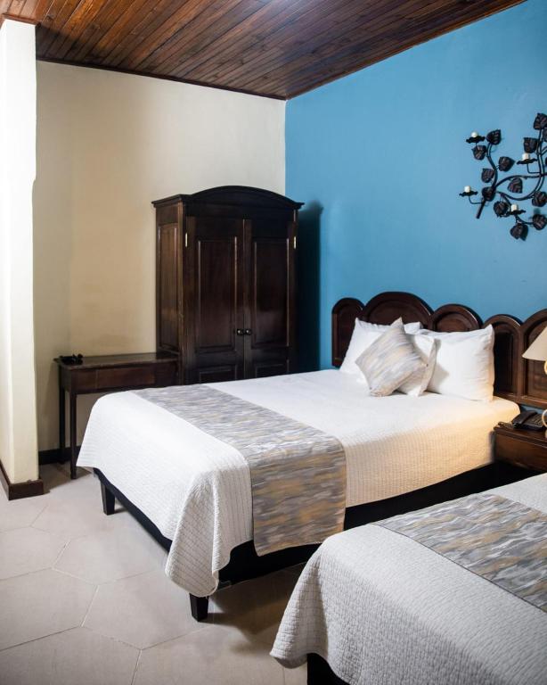Voodi või voodid majutusasutuse Hotel Plaza Copan toas