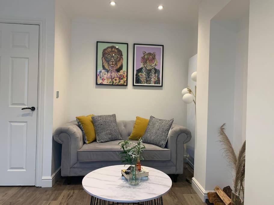 a living room with a couch and a table at Alto - Lovely 2 Bedroom Serviced Apartment Bristol by Mint Stays in Bristol