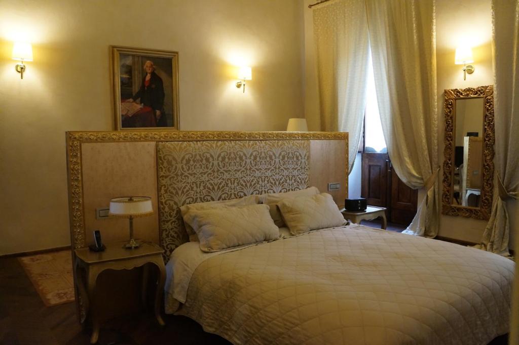 Postel nebo postele na pokoji v ubytování Palazzo Carletti