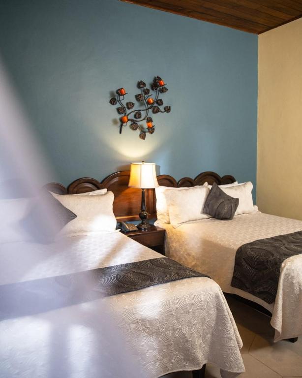 Voodi või voodid majutusasutuse Hotel Plaza Copan toas