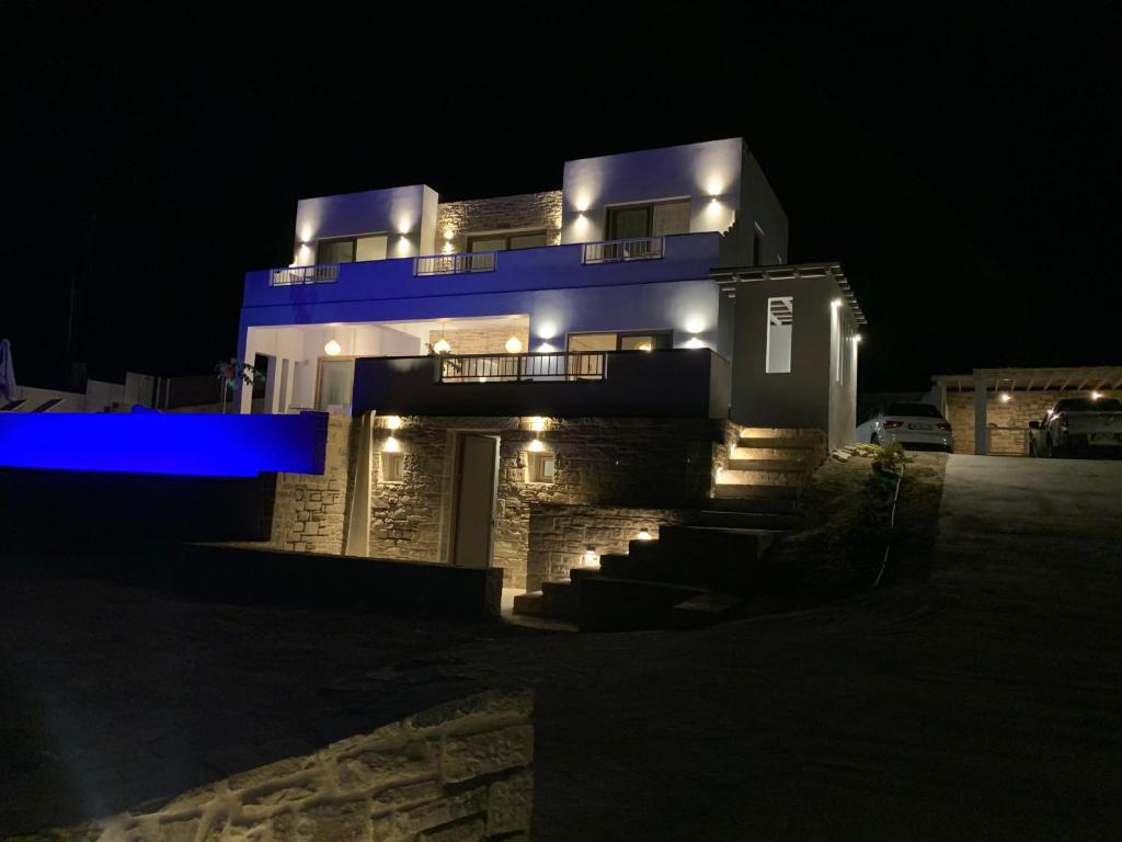 a large house with lights on it at night at Villa Olia in Pitsidia