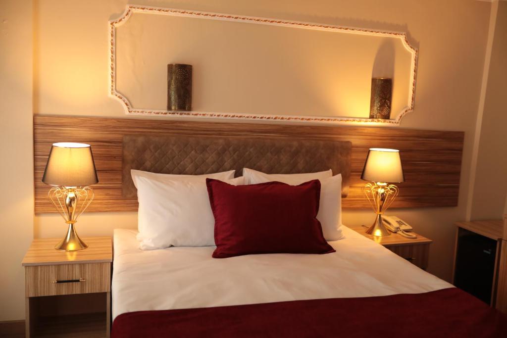 A bed or beds in a room at Gülec Konak Hotel