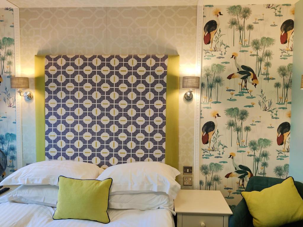 a bedroom with a bed and a wall with birds at The Bingham Townhouse in Bingham