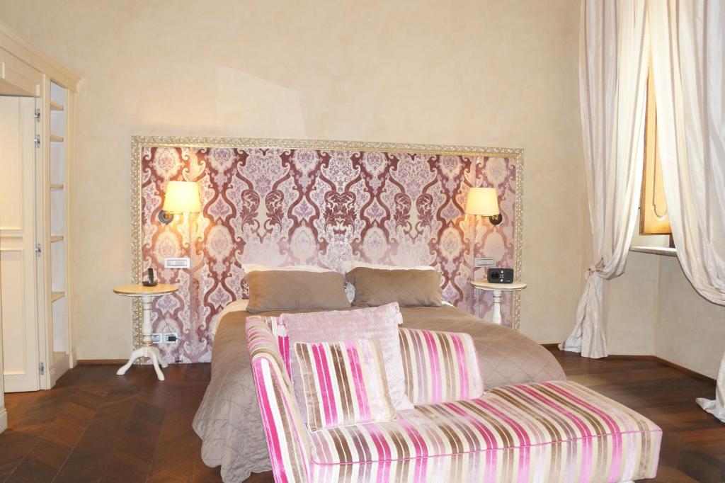 Postel nebo postele na pokoji v ubytování Palazzo Carletti