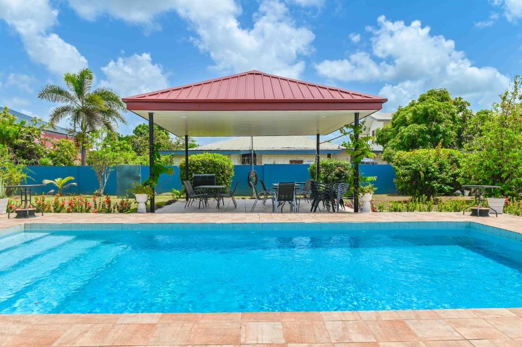 a swimming pool with a gazebo and a house at Traum House in Saint Augustine