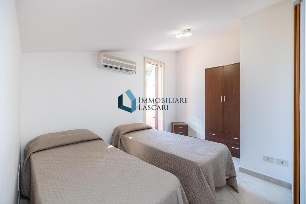 Łóżko lub łóżka w pokoju w obiekcie Villa Siragusa con piscina condominiale