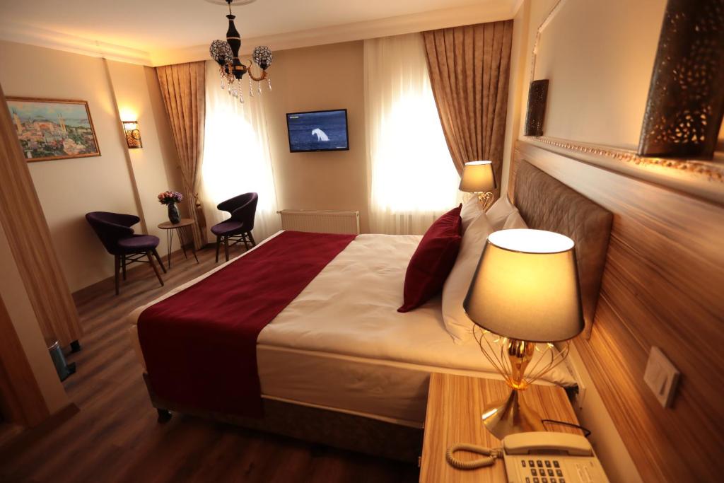 A bed or beds in a room at Gülec Konak Hotel