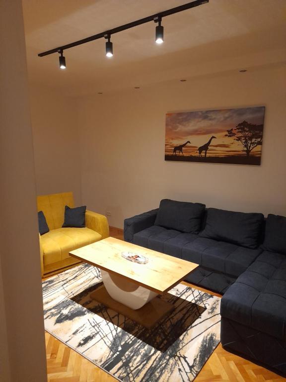 a living room with a couch and a table at Holiday apartaments 2 in Niš