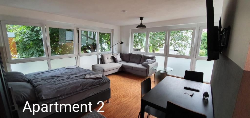 a living room with a couch and a table at SEVIS Outlet Apartments in Metzingen