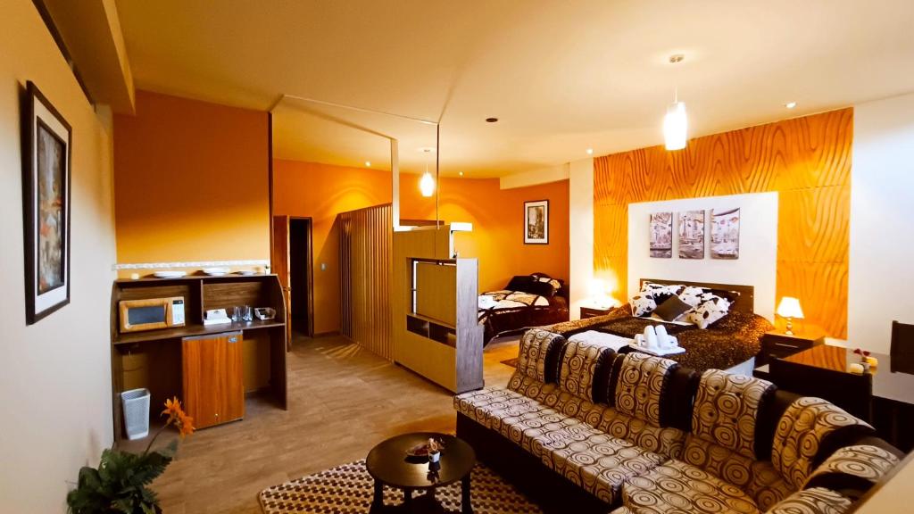 a large living room with a couch and a living room with at Hotel Gran Aurum in La Paz