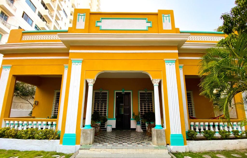a yellow house with an orange at Mansion Bahia Manga in Cartagena de Indias