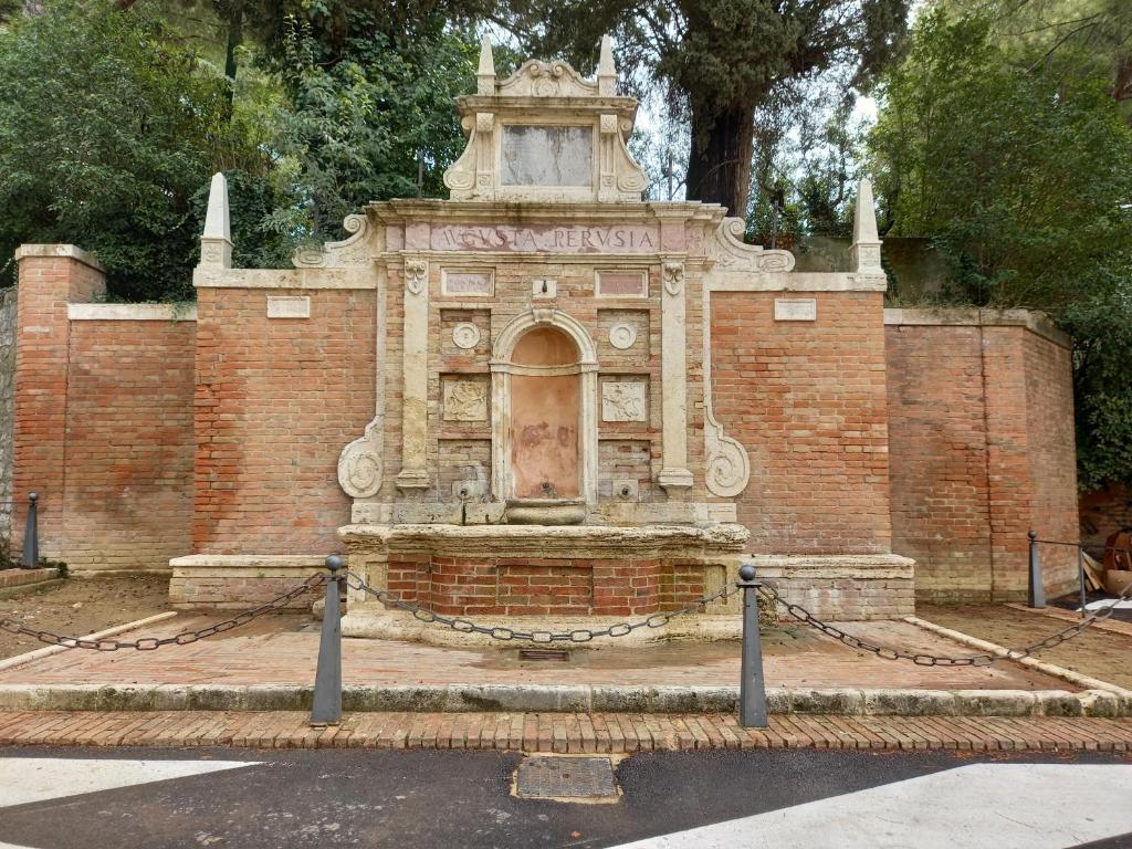 a fountain in the middle of a brick wall at La Casina di Veggio in Perugia