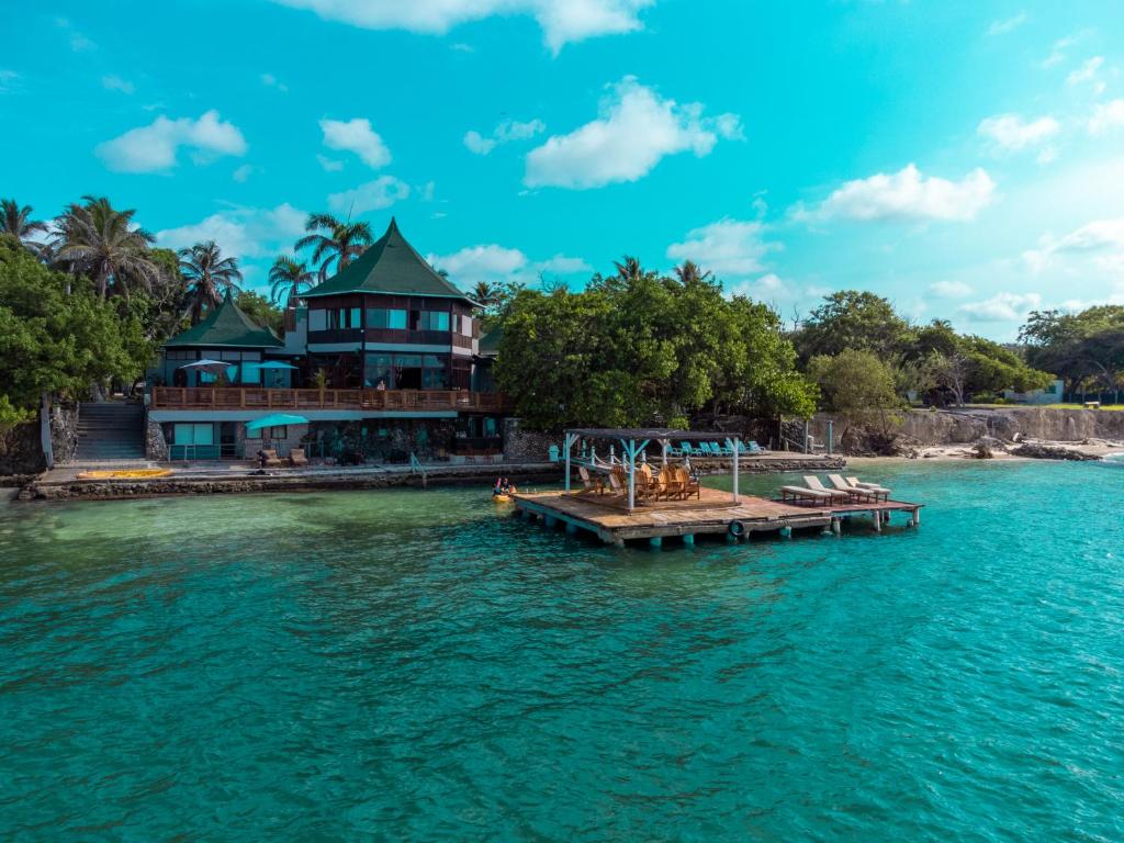 a house on a dock in the water at Rosario EcoHotel in Isla Grande