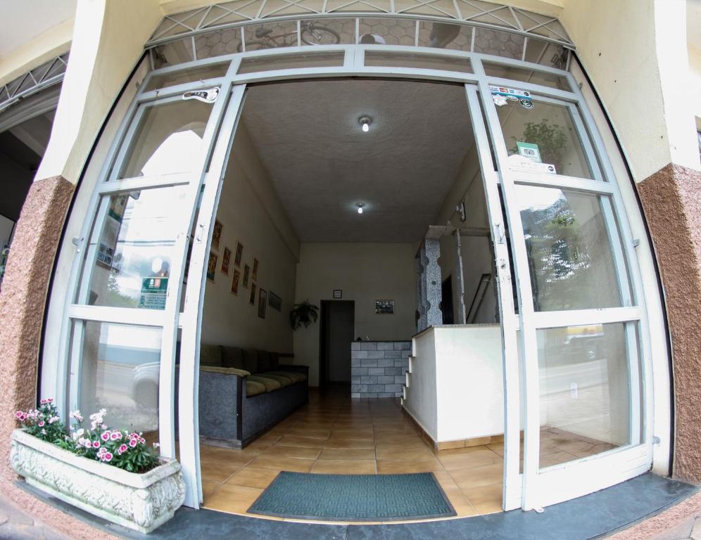 an entrance to a building with large glass doors at Pousada Pouso Alto in Pouso Alto