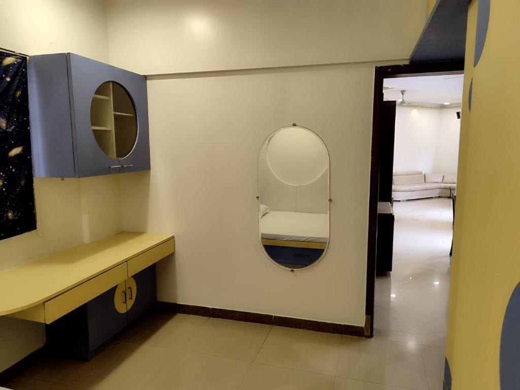 a bathroom with a mirror and a sink and a bed at Just homes 2 bhk Service appt in Pune
