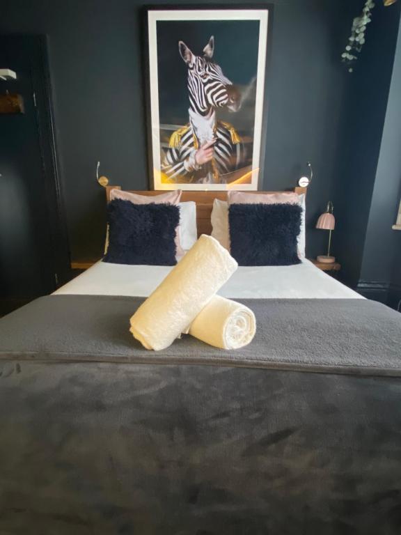 a bedroom with a bed with a zebra picture at Salt Life Studio in Brighton & Hove