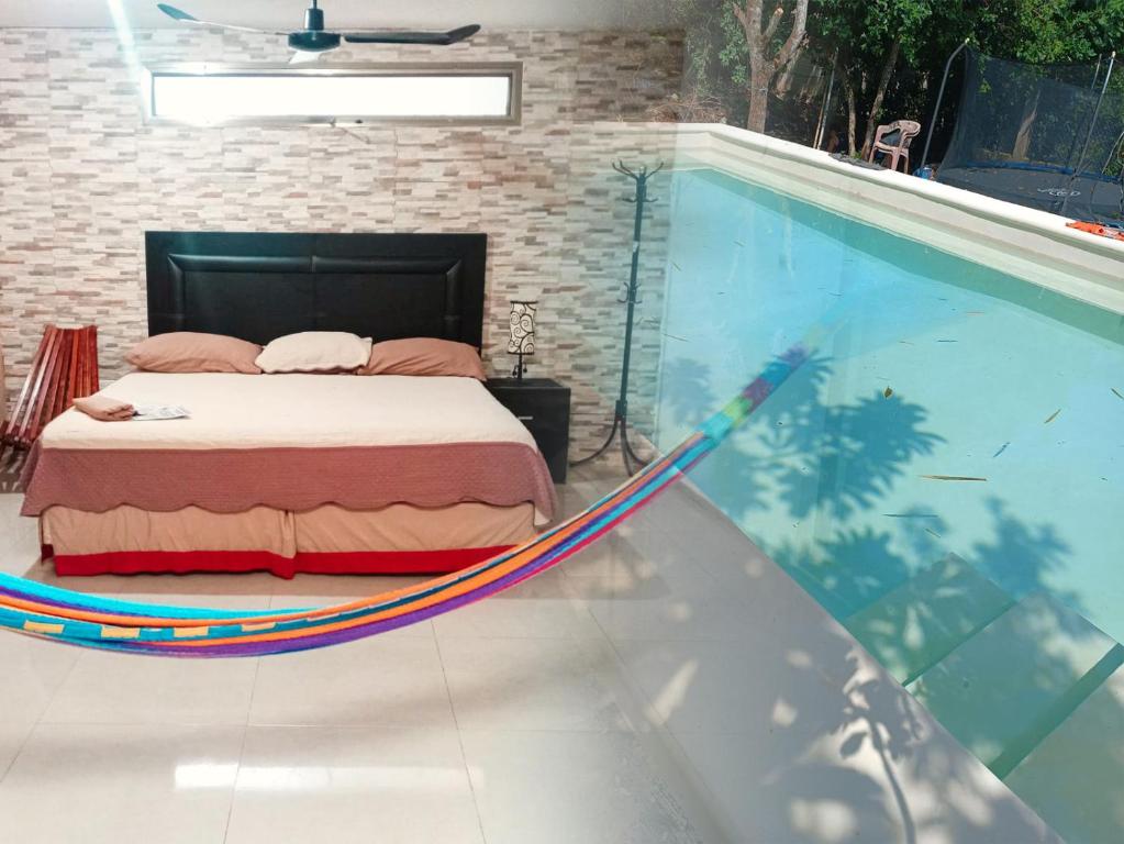 a bed in a hammock next to a swimming pool at CASA LILI 2: Luxurious/Amplio/Hot Water/Economic/Wifi/TV in Valladolid