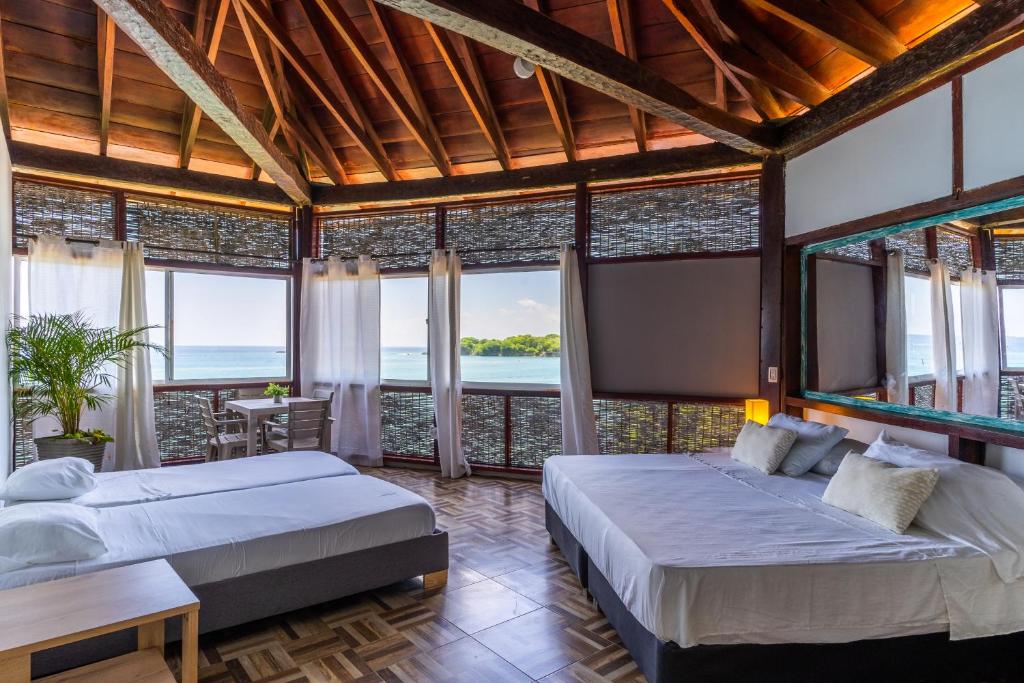 Postel nebo postele na pokoji v ubytování Rosario EcoHotel