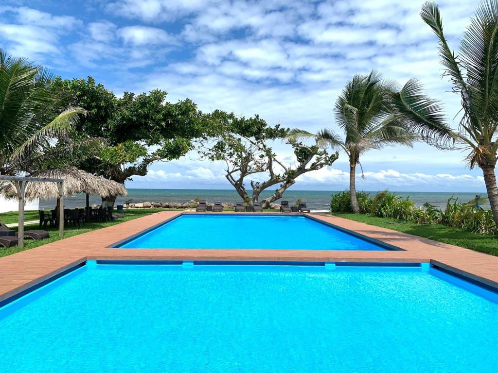 a swimming pool with a view of the ocean at Mar De Estrellas - Hotel in Costa Esmeralda