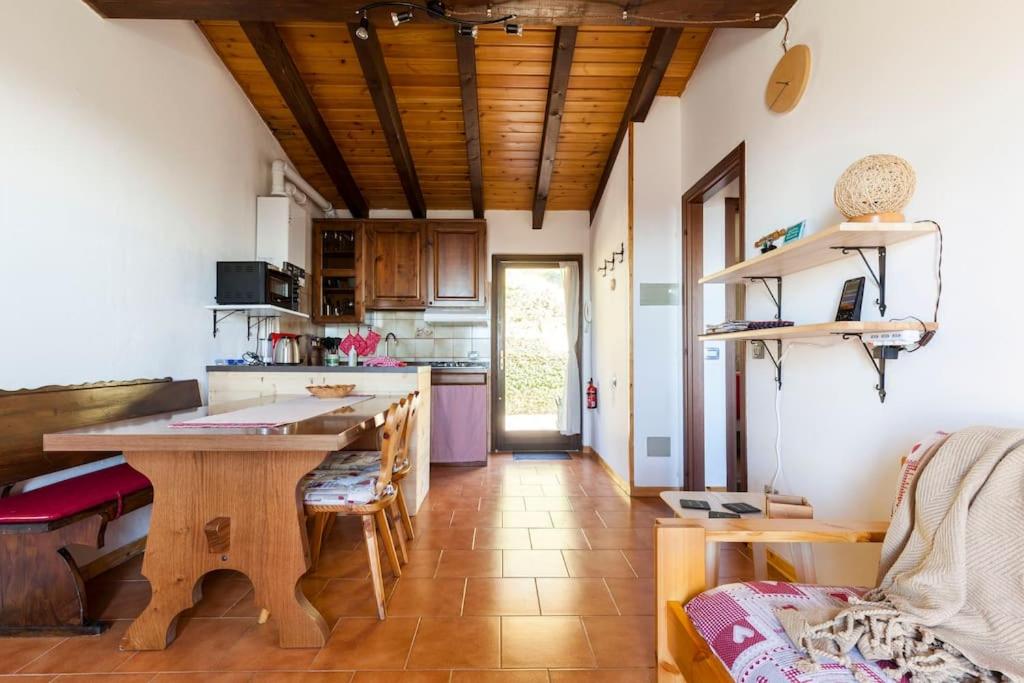 a kitchen with a wooden table in a room at Panorama1200A, in the Heart of the San Fermo Hills in Adrara San Rocco