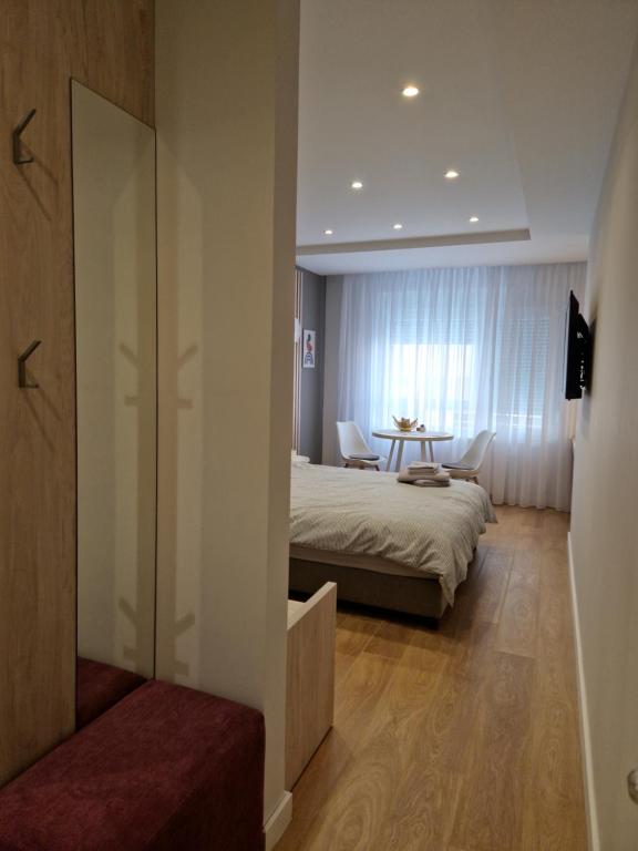 Postel nebo postele na pokoji v ubytování PRONTO apartman & PRONTO studios