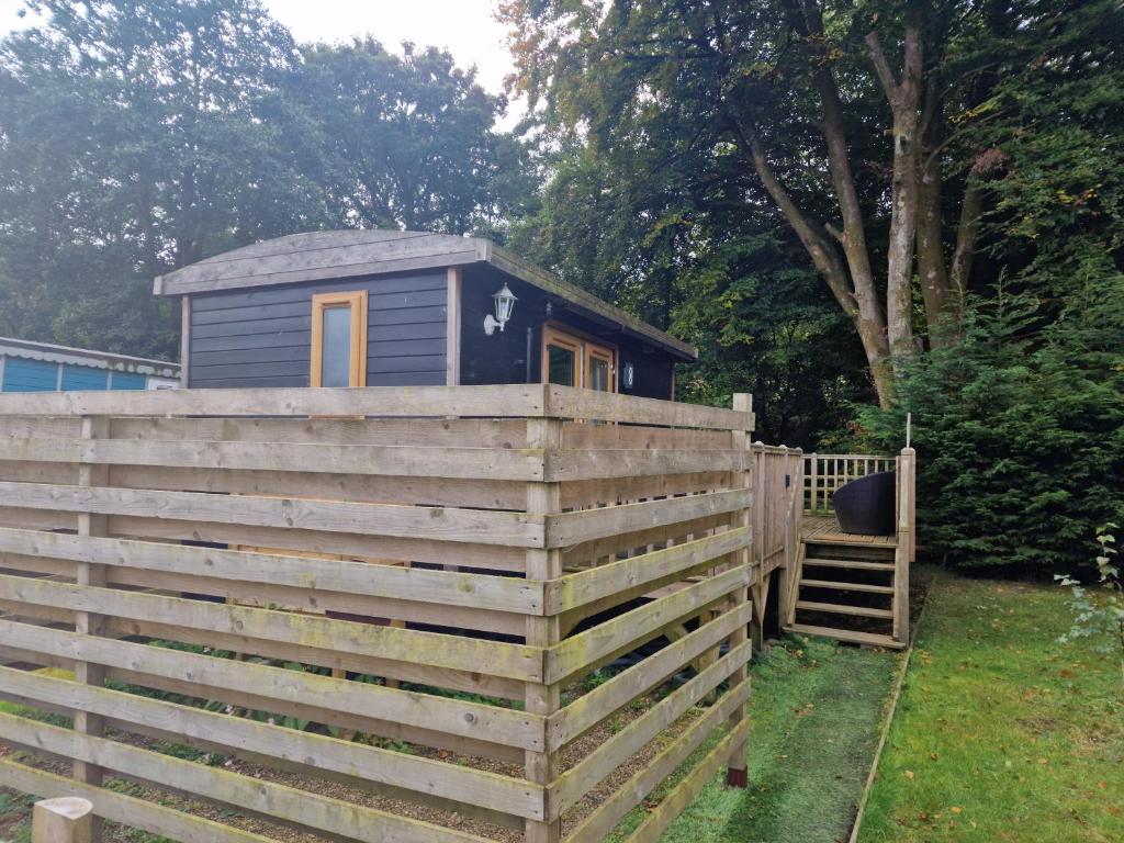 a tiny house on top of a fence at Glamping Hut - Riverside 1 in Welshpool