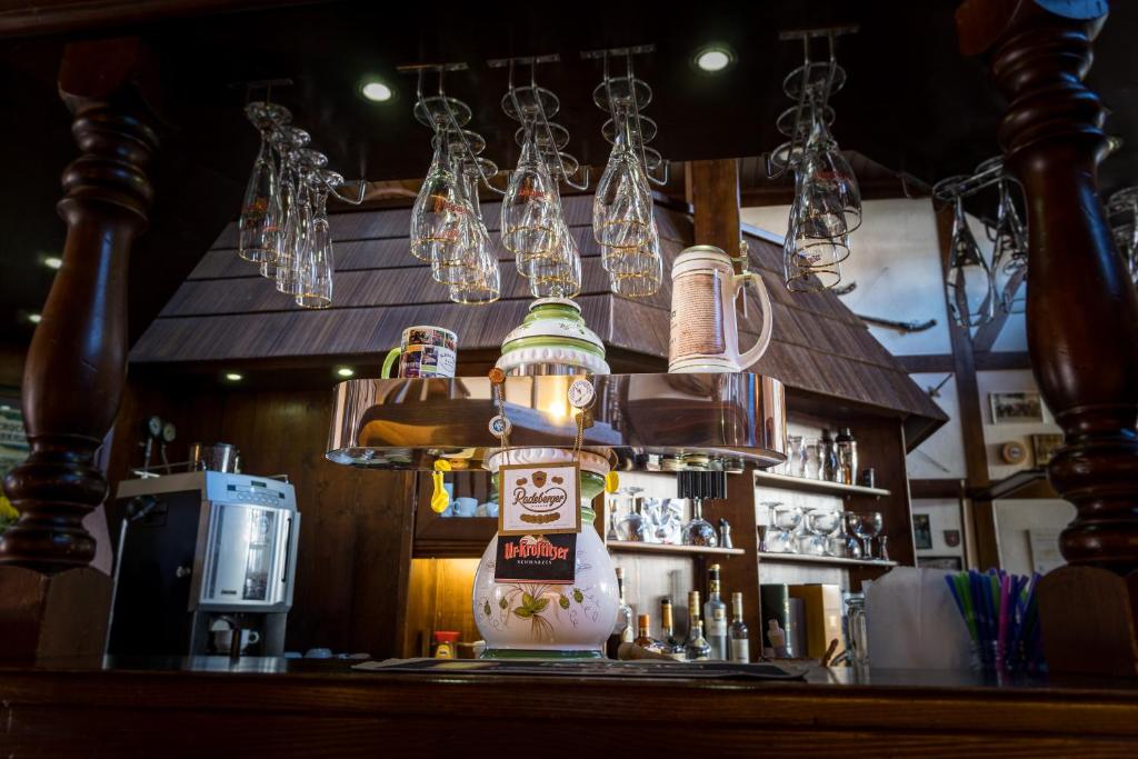 a bar with a light fixture above a counter at Landhotel &amp; Restaurant Kains Hof in Uhlstädt