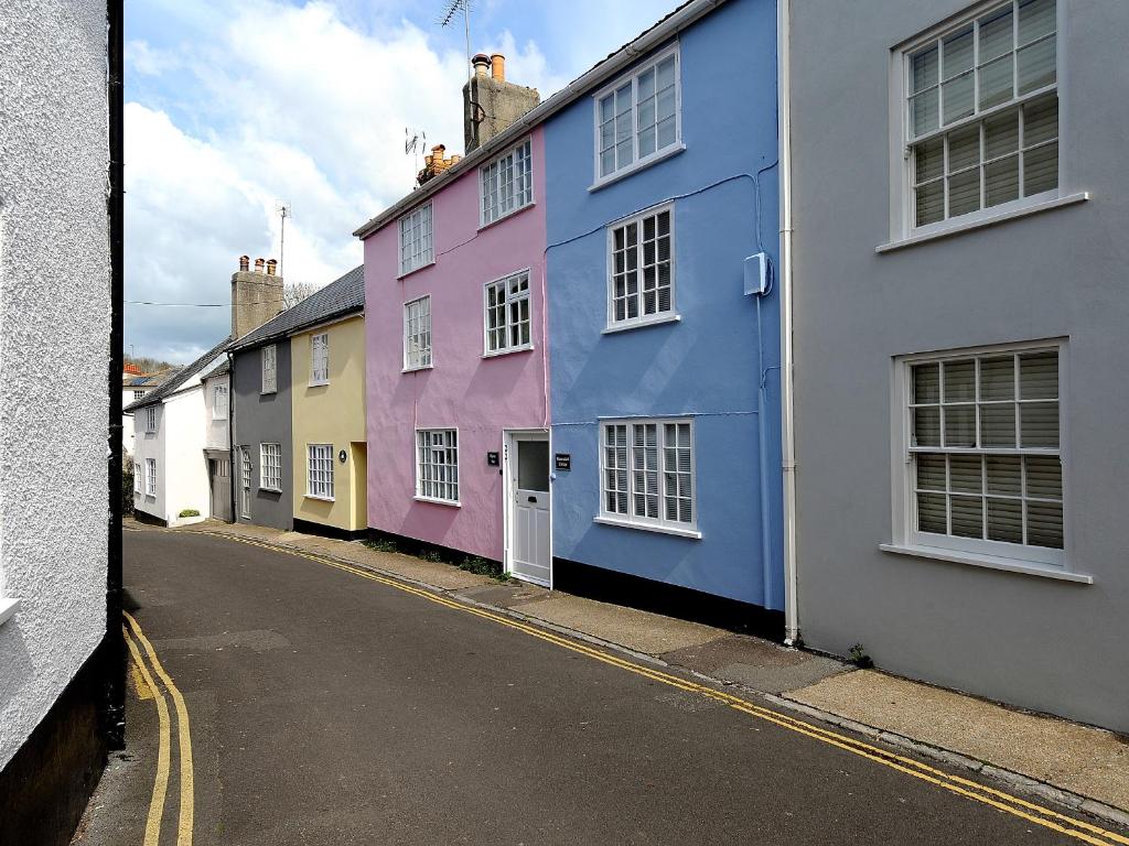 a row of colorful houses on a street at Watersplash Cottage in Lyme Regis