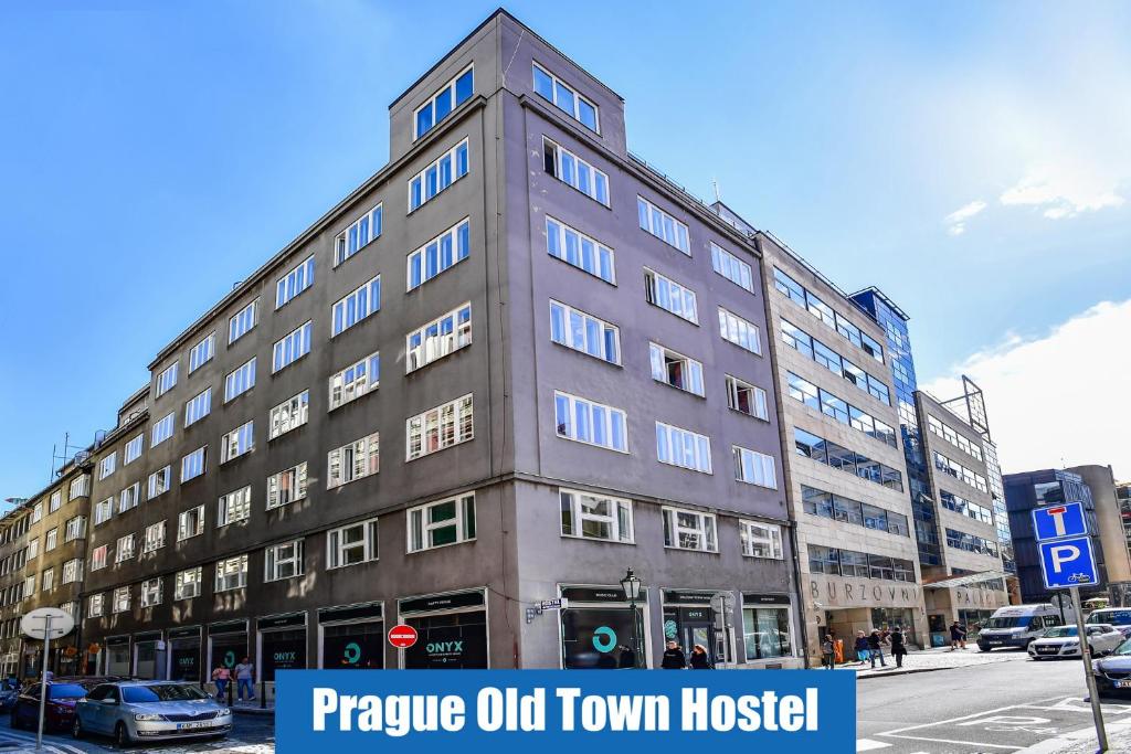 ein hohes Gebäude in einer Stadtstraße mit einem Schild in der Unterkunft Prague Old Town Hostel in Prag