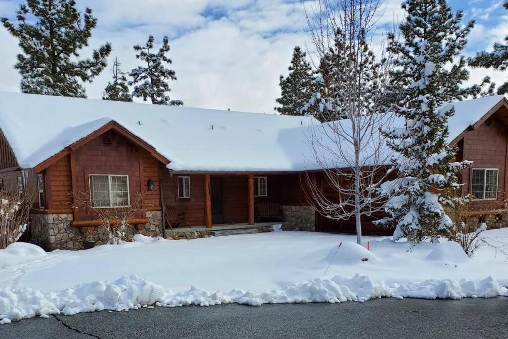 a house covered in snow with trees in front of it at CUSTOM SINGLE STORY CABIN WITH JACUZZI POOL TABLE & BIG GAME ROOM WITH ARCADE games in Big Bear Lake