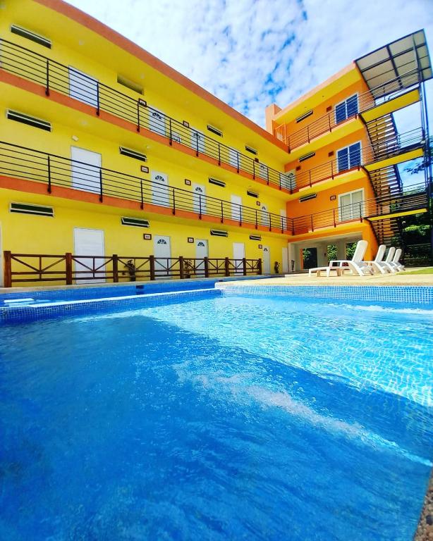 a swimming pool in front of a building at VILLAS DULCE SUEÑOS RESIDENCIAL in Rincon de Guayabitos