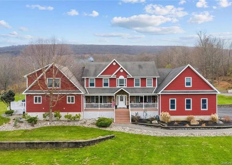 a large red house with a large yard at Mid-Hudson Estate: 11 acres, Pool, 1 hr to NYC in Monroe