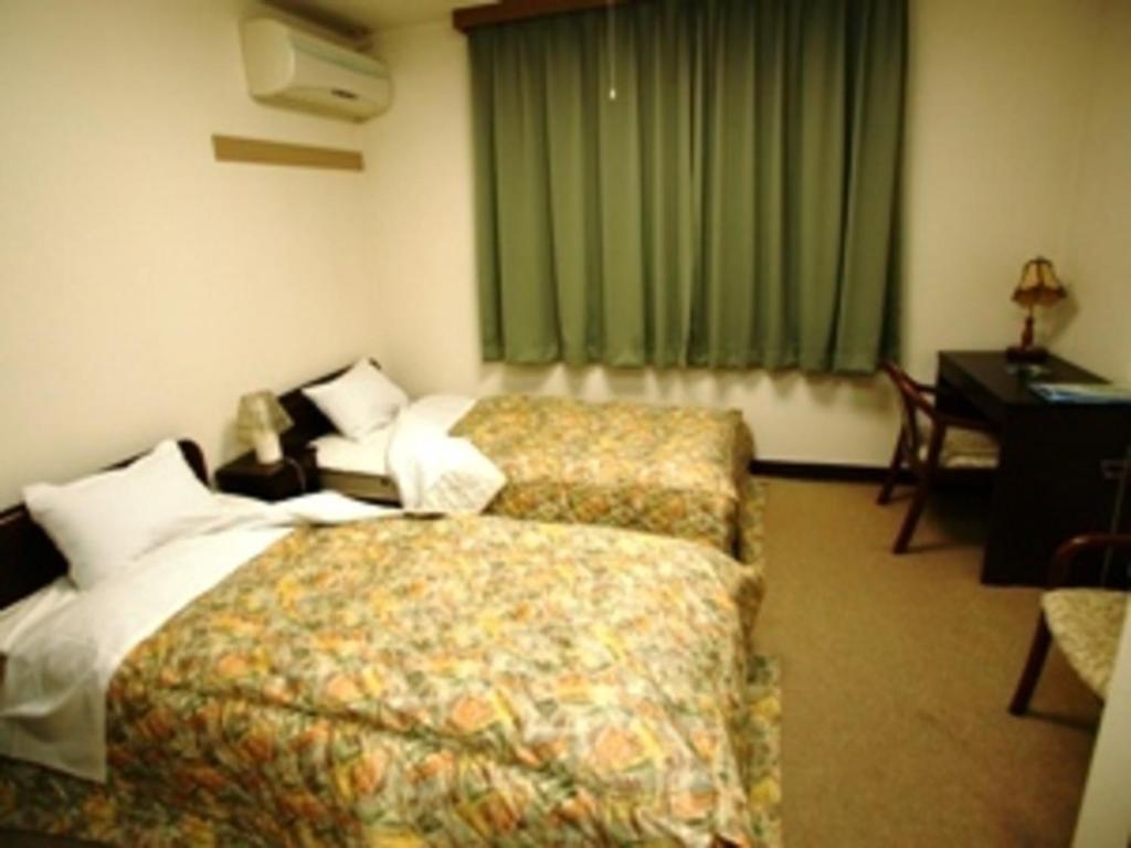 Postel nebo postele na pokoji v ubytování iseshima youth hostel