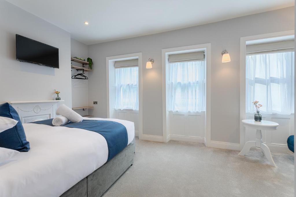 a bedroom with a bed and a tv on the wall at Number 31 Boutique Townhouse in Galway