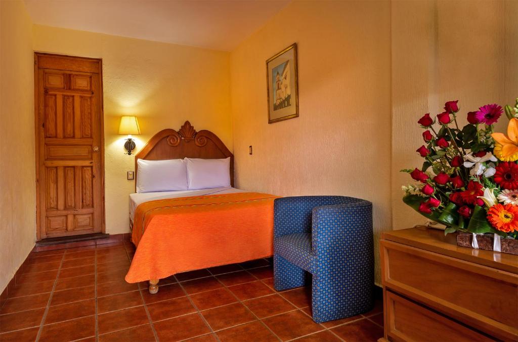 Postel nebo postele na pokoji v ubytování Hotel la Parroquia