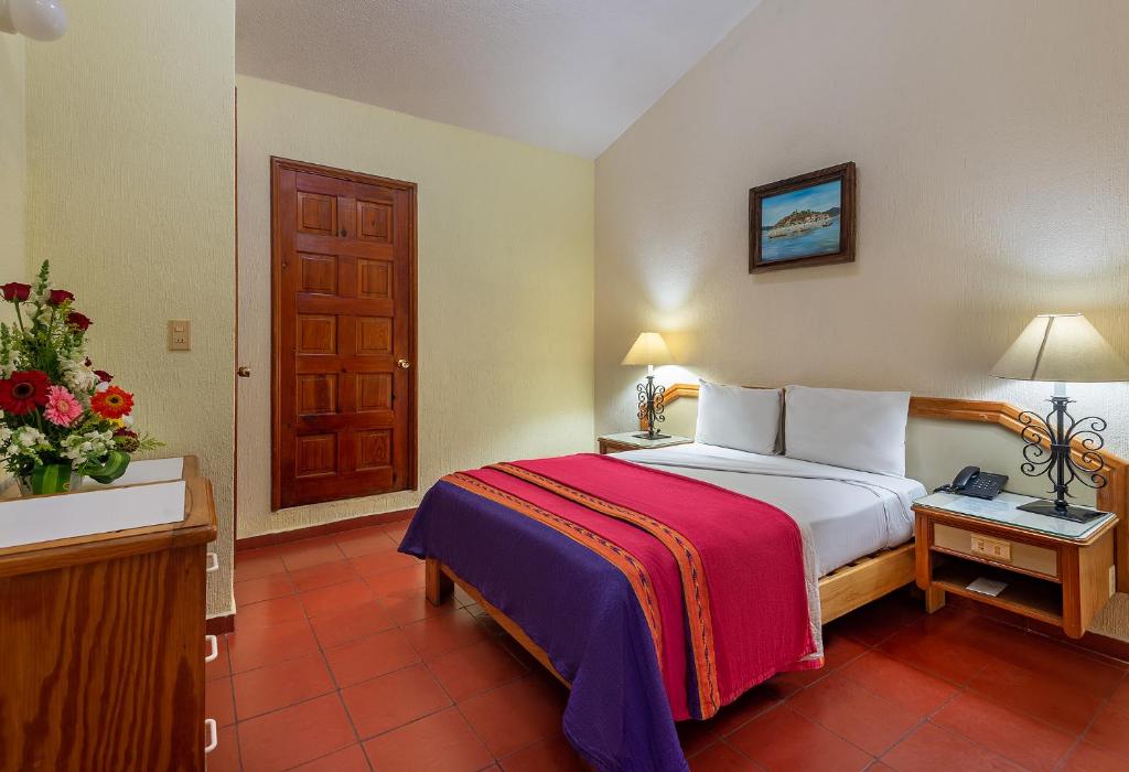 Postel nebo postele na pokoji v ubytování Hotel la Parroquia