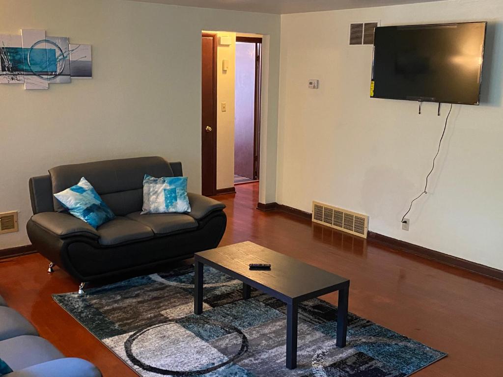 a living room with a couch and a tv at Spacious 3bedroom free wine,WiFi,and parking in Milwaukee