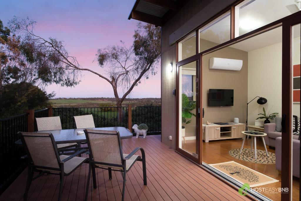 a patio with a table and chairs on a deck at Rural 5 Star Villa's with Resort Amenities in Cowes