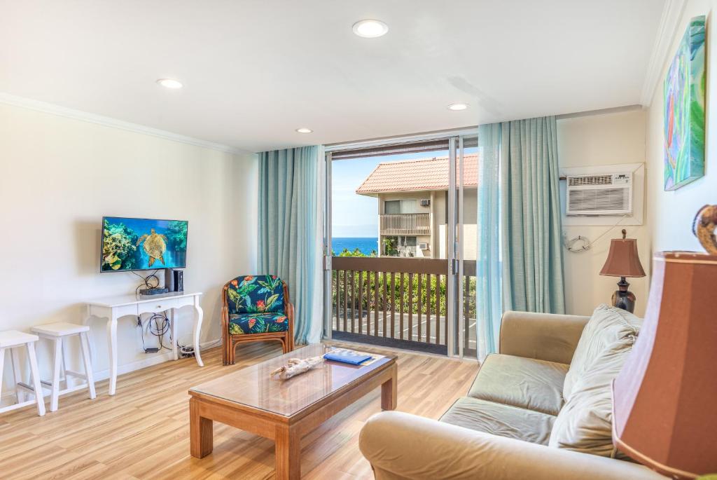 una sala de estar con un sofá y una mesa en Kona Mansions 123, en Kailua-Kona