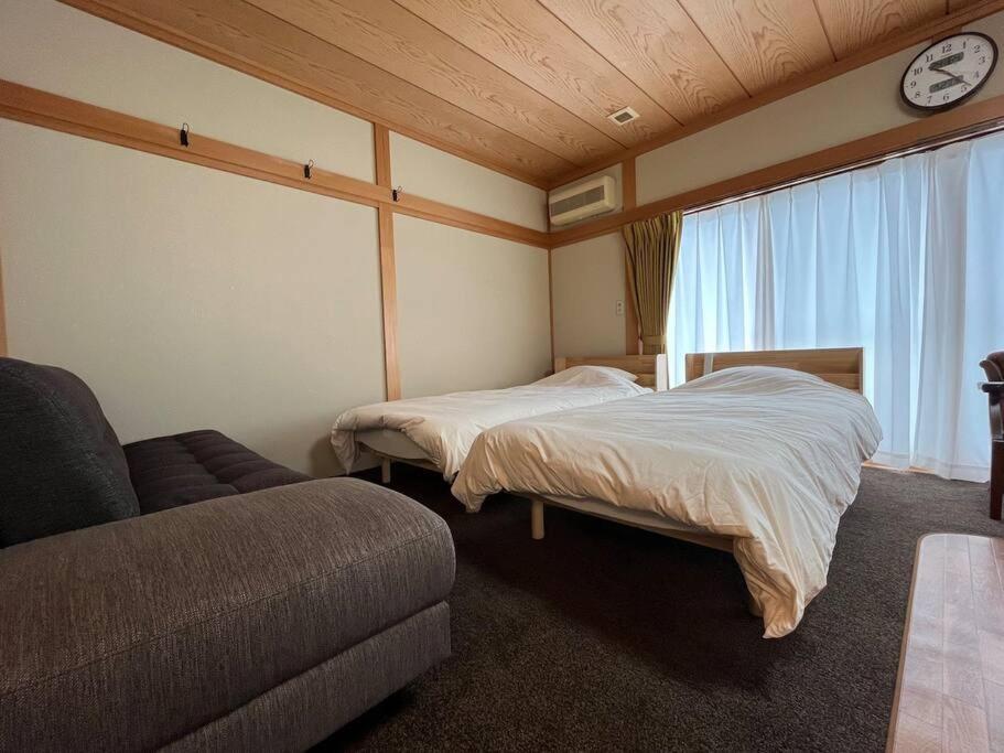 Postel nebo postele na pokoji v ubytování 草津温泉 湯之風