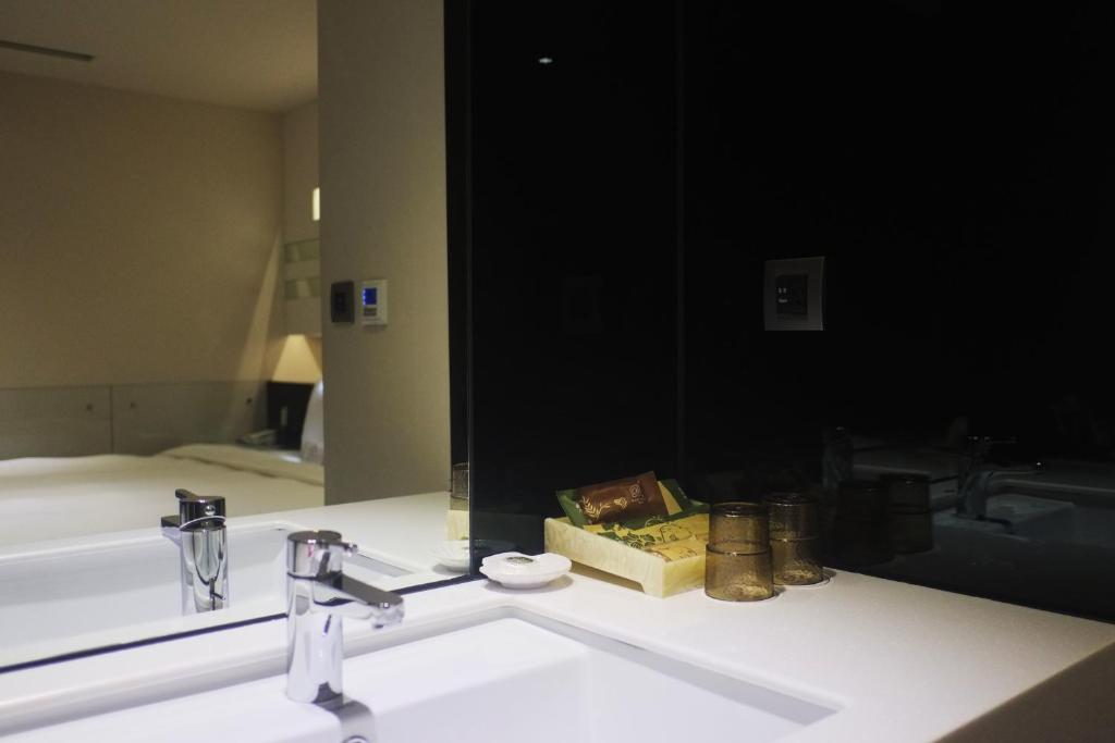 a bathroom with a sink and a large mirror at Beauty Hotels Taipei - Hotel B6 in Taipei