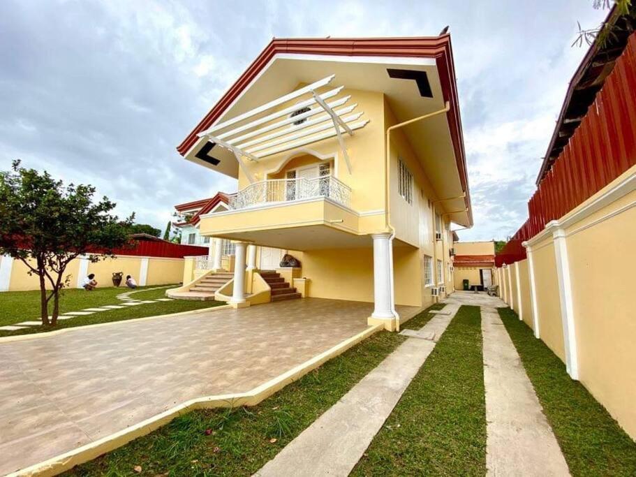 a yellow house with a red roof at Big & Elegant w/Nice Location nr SM &Ateneo Matina in Davao City