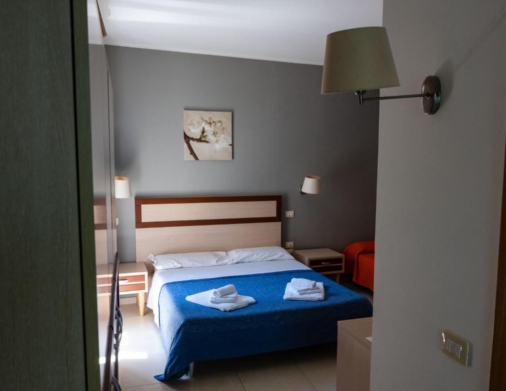 Postel nebo postele na pokoji v ubytování Hotel Milomax