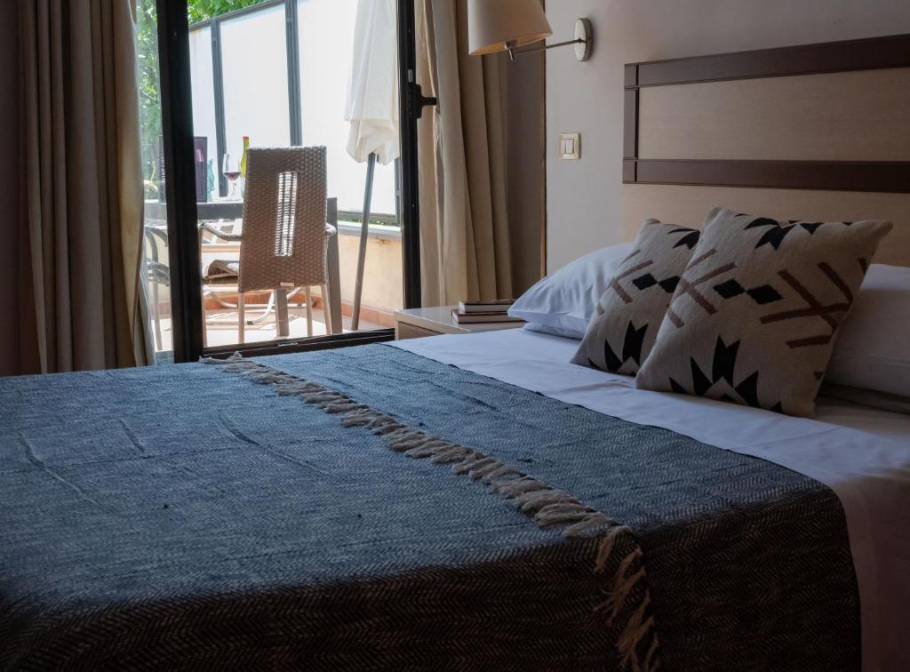 Postel nebo postele na pokoji v ubytování Hotel Milomax