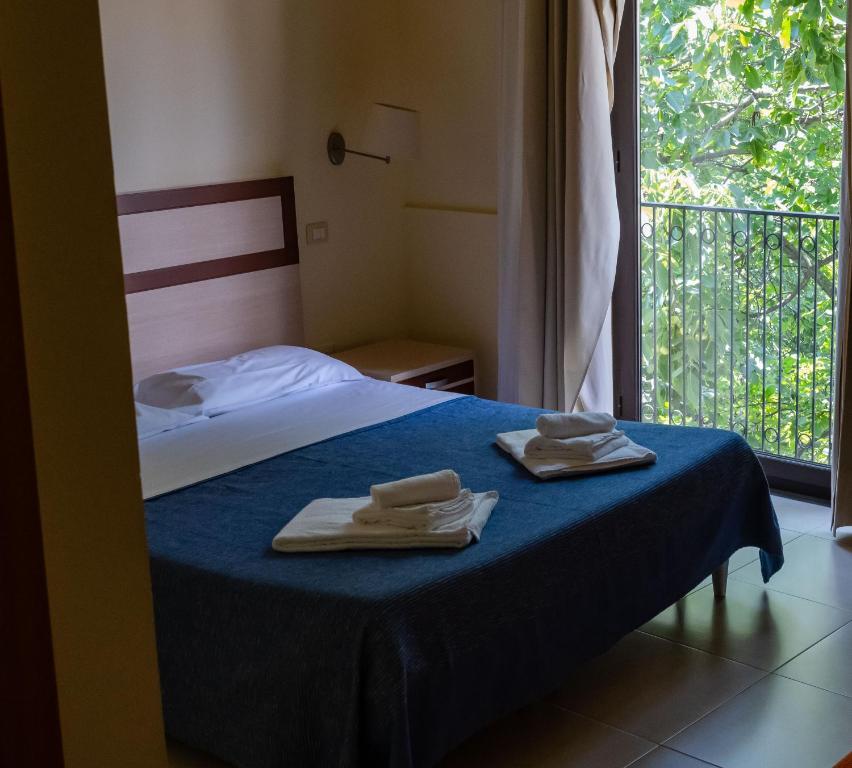 Postel nebo postele na pokoji v ubytování Hotel Milomax