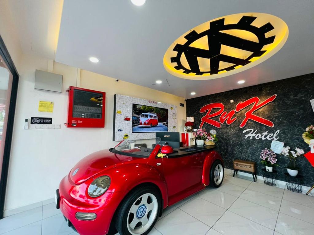 a room with a red car parked in a store at RNK BoutiQue HOTEL in Jitra