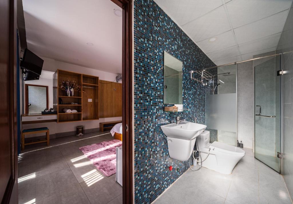 a bathroom with a sink and a toilet and a shower at The K'rin Villa in Da Lat