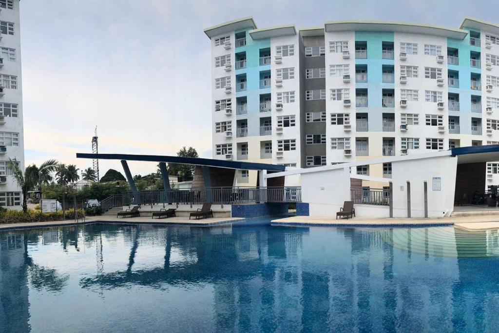 a large building with a pool of water in front of it at Seawind Condominium 2BR unit in Davao City