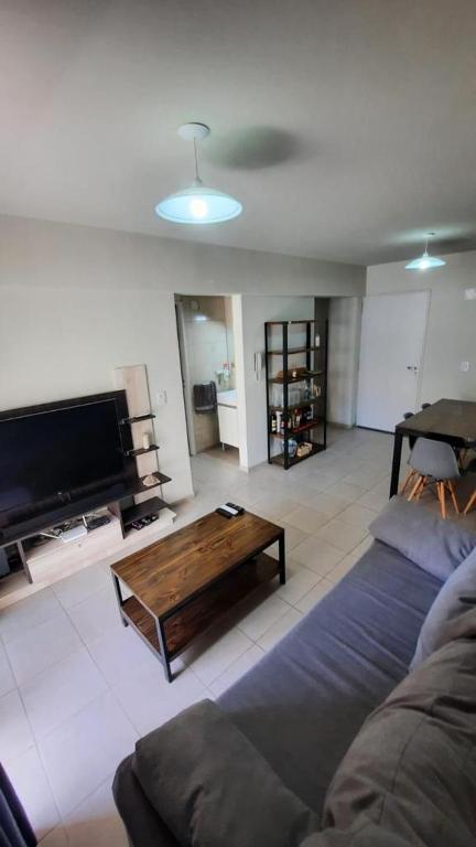 a living room with a couch and a coffee table at Departamento super comodo y tranquilo in La Cieneguita