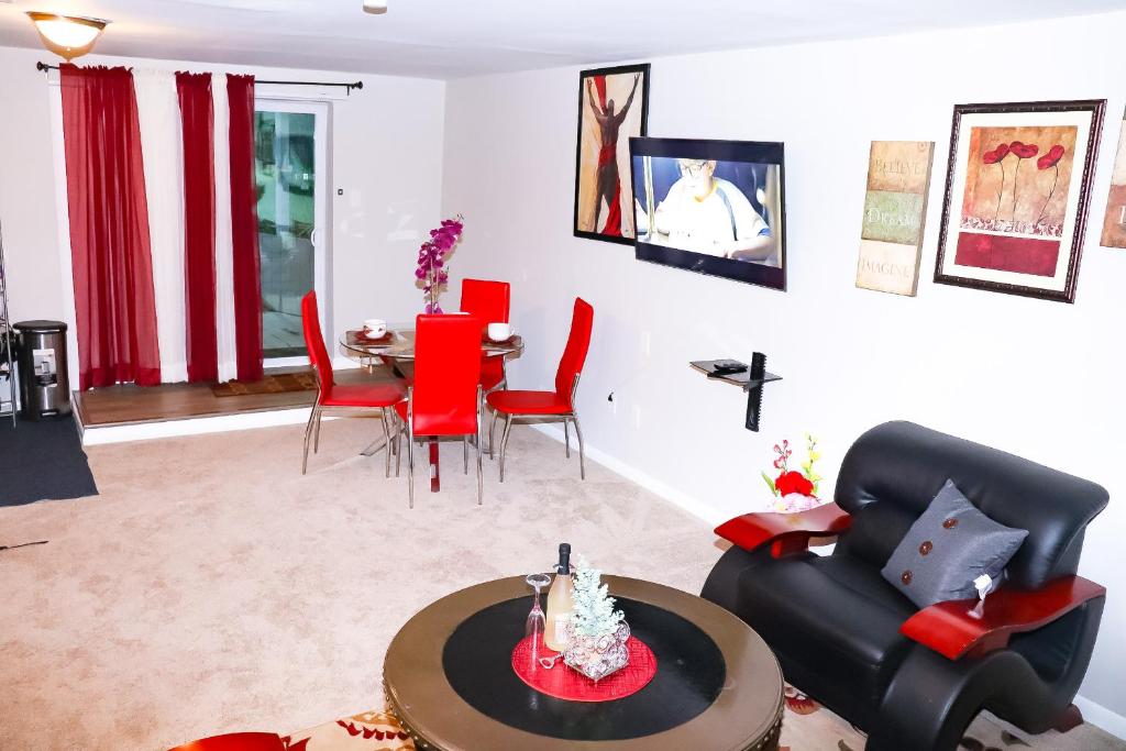 a living room with red chairs and a table at Luxury 2BR 1bt Suite basement Vacation House Private Entrance in Lithonia